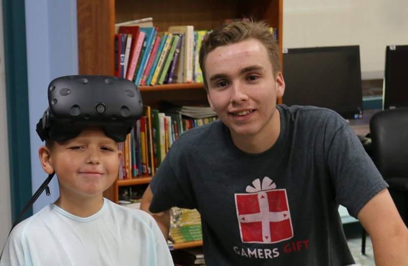 A volunteer at Gamer’s Gift with a patient at Valley Children’s Hospital. Photo courtesy of Dillon Hill.
